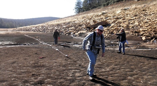 Ben Perdue dragging the OhmMapper array under Dr. Herman's watchful eye as part of subsurface resistivity survey.