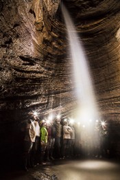 Participants of the Wilderness Institute stand behind a waterfall in Starnes Cavern.