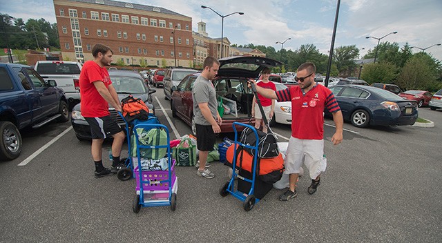 Members of the RU Rugy Club and other clubs help Amy Gaetner '87 with moving in her daughter Gabby Jones' things as they prepare for the start of the new school year.