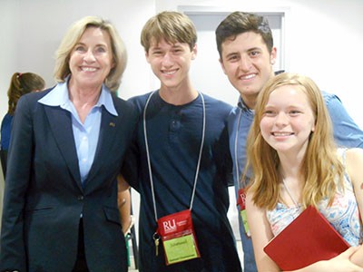 Radford University President Penelope W. Kyle shares a moment with three students