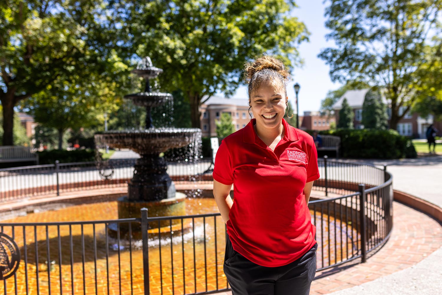 female student in front of fountain