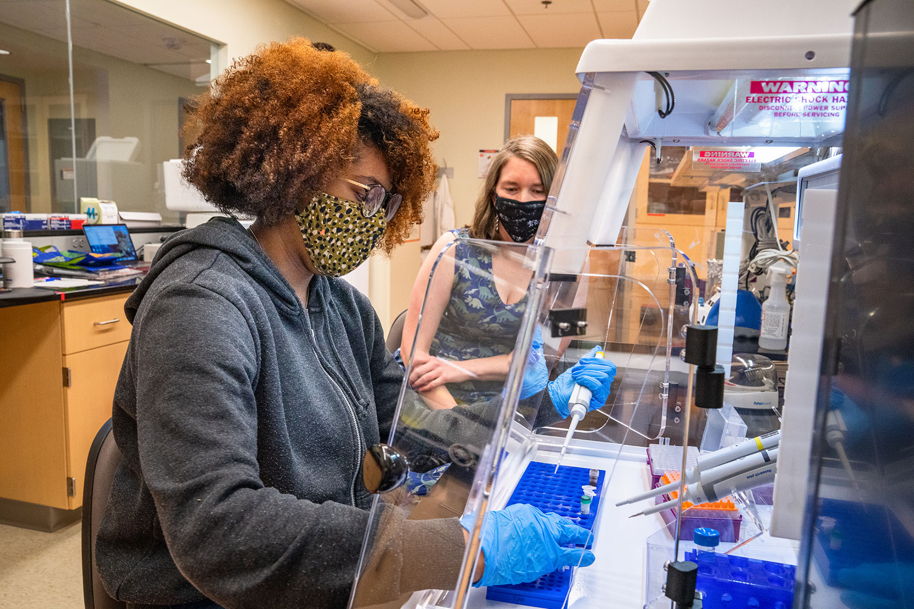 student in bio lab with professor