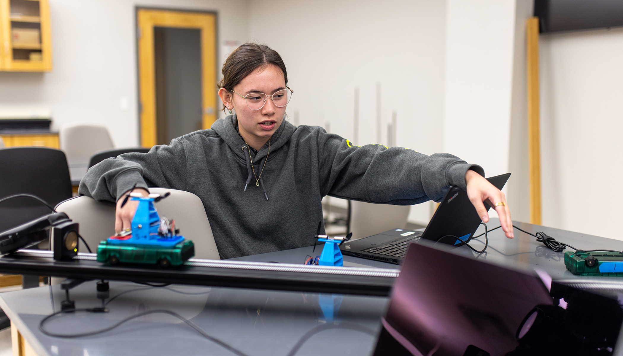 student conducting research in classroom