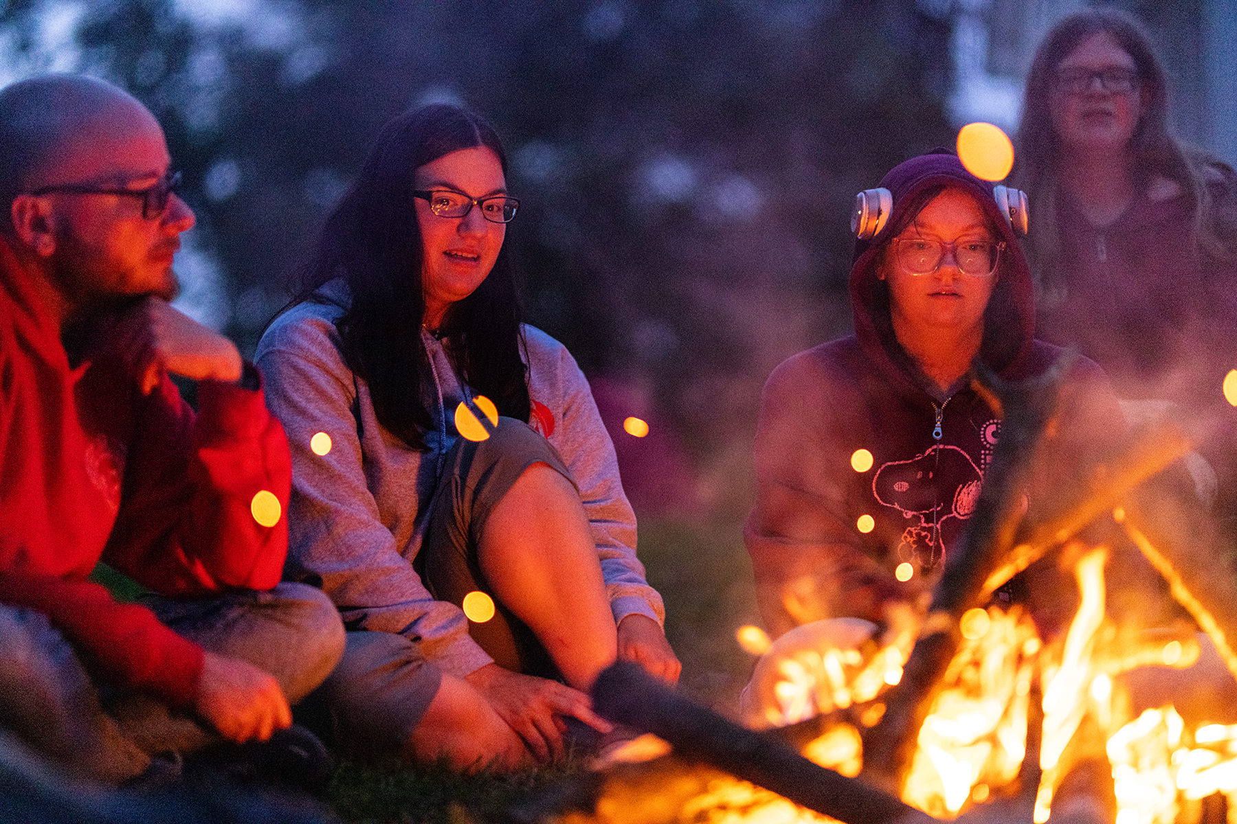 students sitting by the fire after a day of research