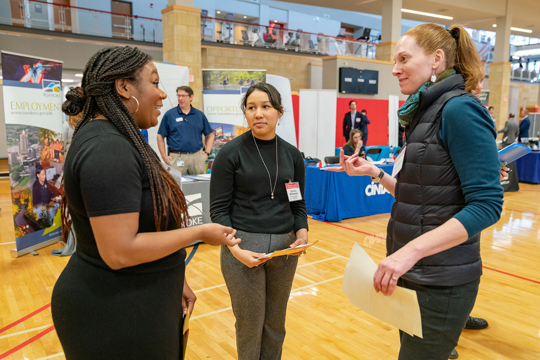 students talking with recruiter at career fair