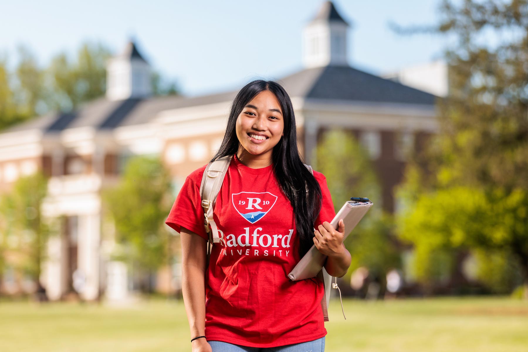 Student in front of Hemphill Hall