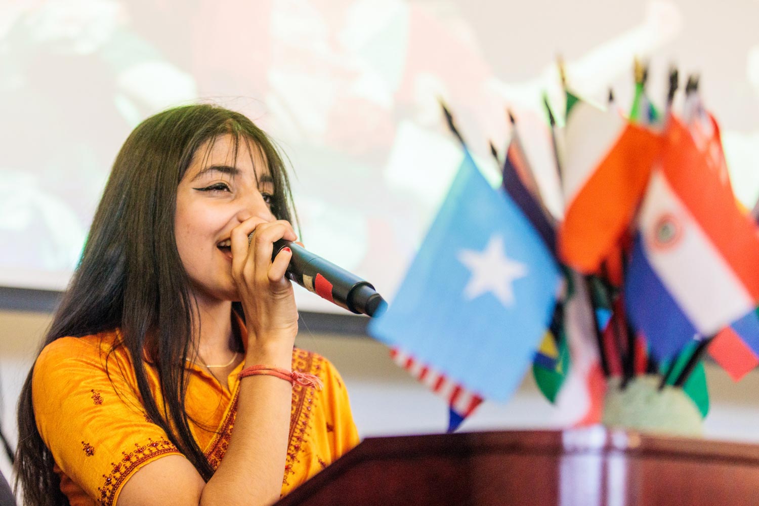 student with microphone at international event