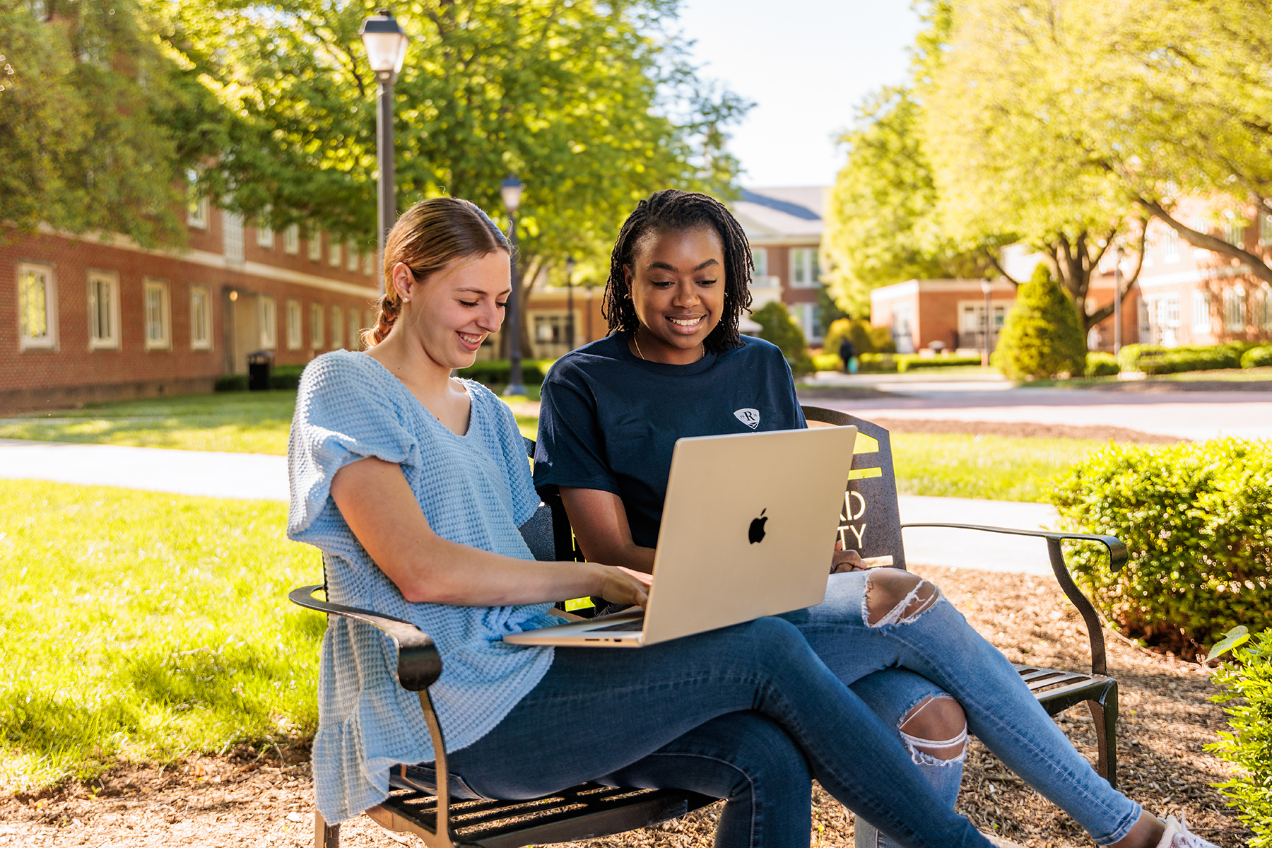 students looking at laptop together