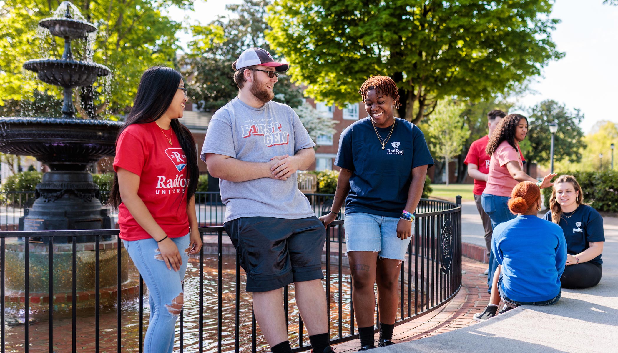 students chatting and hanging out at fountain