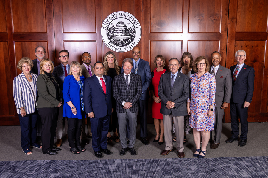 The 2023-24 Radford University Board of Visitors posed in front of the university seal