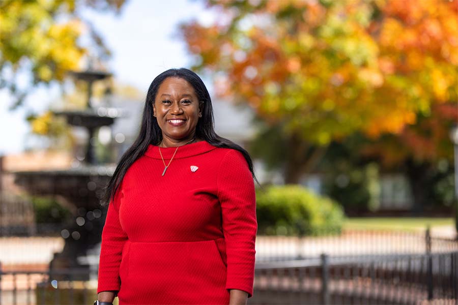 Radford University’s Angela Joyner, Ph.D., stands in front of the campus fountain.