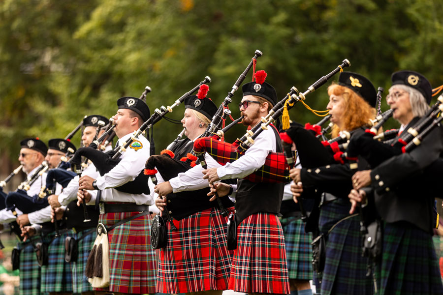 Bagpipers playing, lined up on campus during the Highlanders Festival.