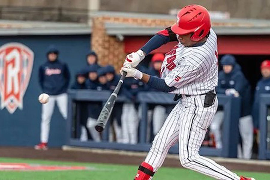 A radford university baseball player hits a ball during a game.