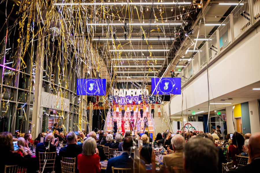 Streamers fly over guests as the total raised is announced during the campaign gala.