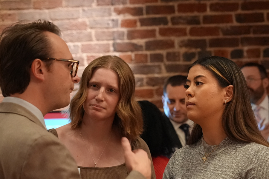 Graduate student Sasha Klucefski '24 (right) joins in a conversation with Board of Visitors Vice Rector Tyler Lester '16 (left) during an Advocacy Day social on January 29.