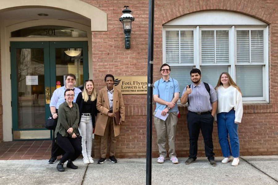 A group of business students stand outside the Roanoke accounting office they visited as part of a recent off-campus trek.