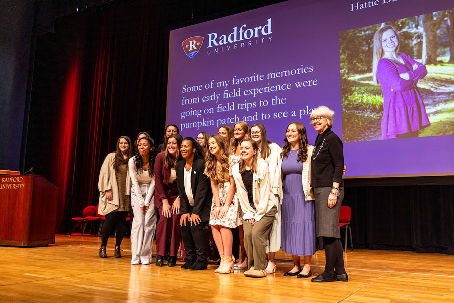 A group of fledging student teachers gather onstage during Radford University's pinning ceremony for the program.