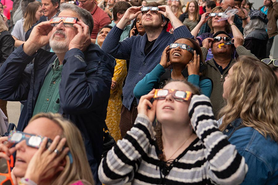 Hundreds of Highlanders and community members gathered on the Center for the Sciences patio and parking lot in hopes of catching a glimpse of the rare solar eclipse on April 8.
