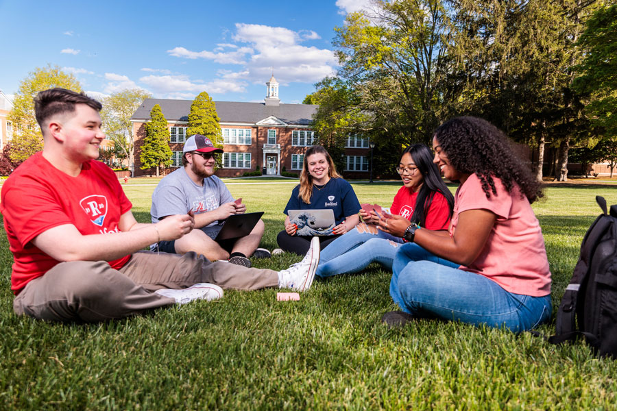 students sitting on lawn talking
