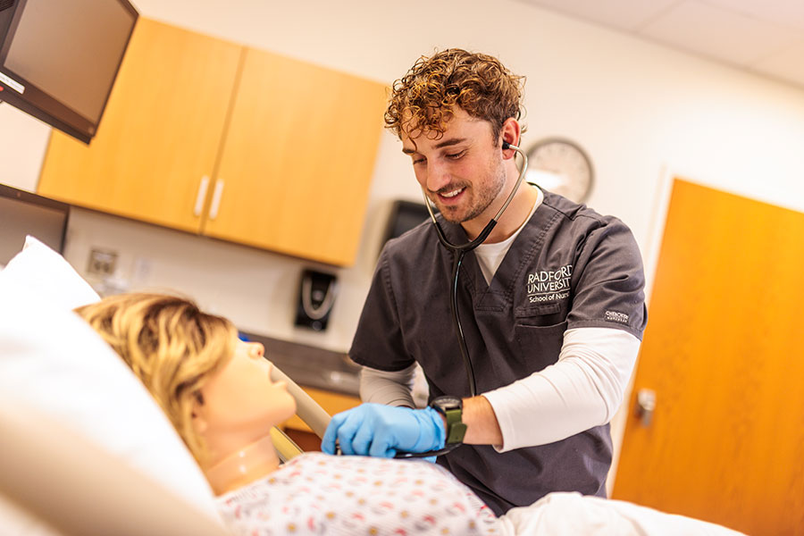 Noah Haddad, senior nursing student and soccer player, in the Clinical Simulation Center on campus.
