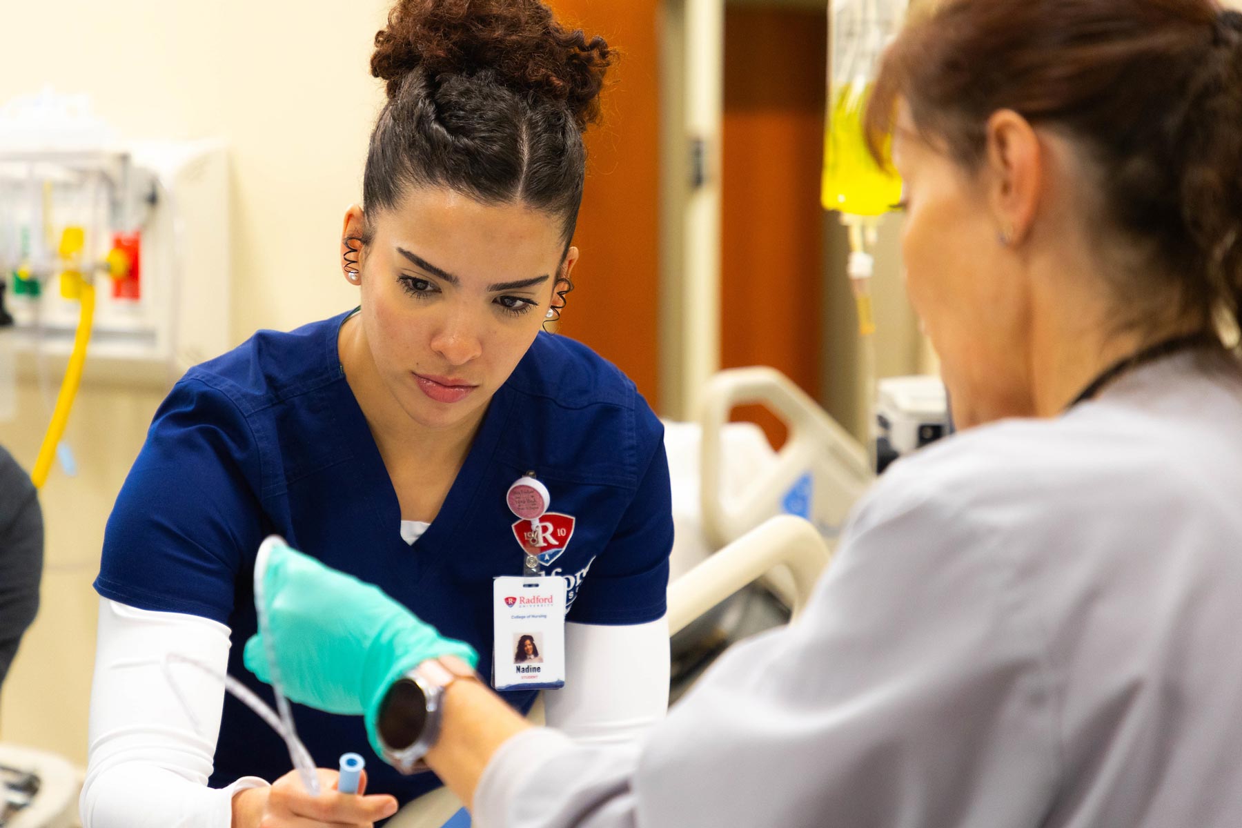 Nursing student and faculty member in lab