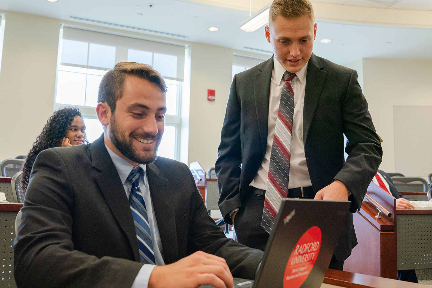 students looking at a laptop screen