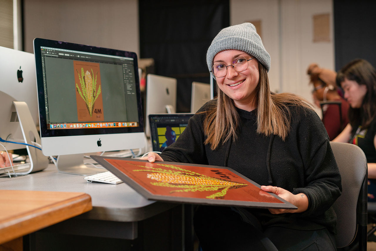 student holding an art piece