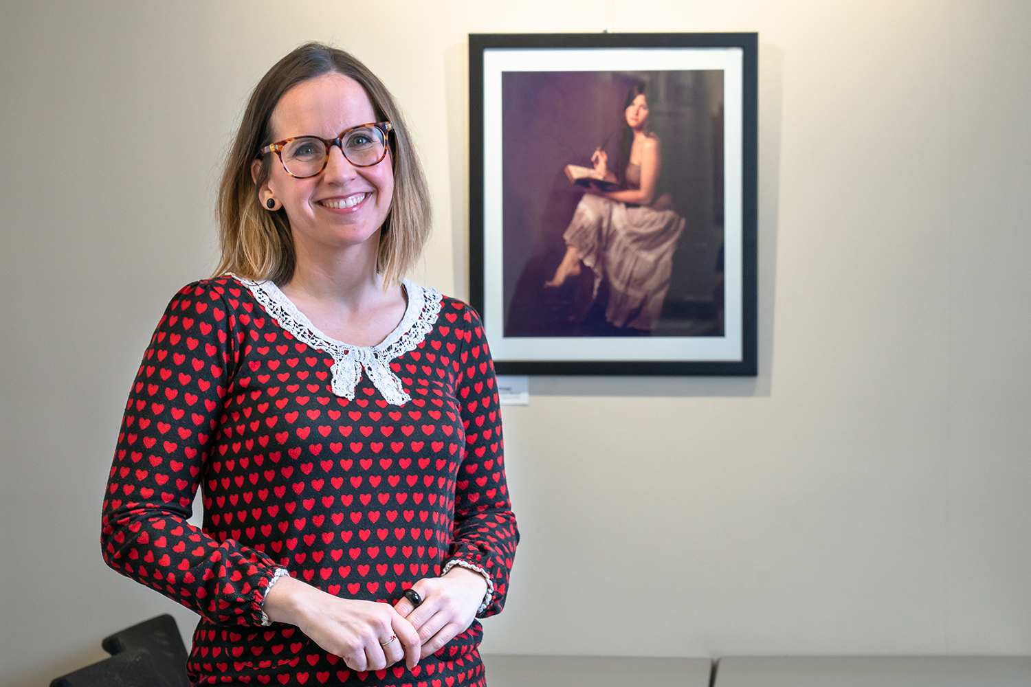 student standing next to a painting