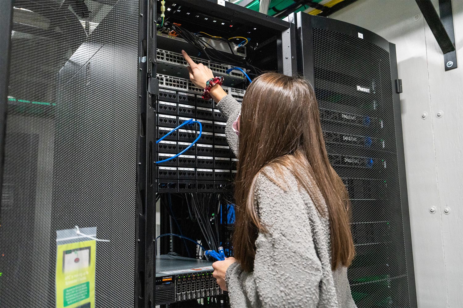 person adjusting server cords