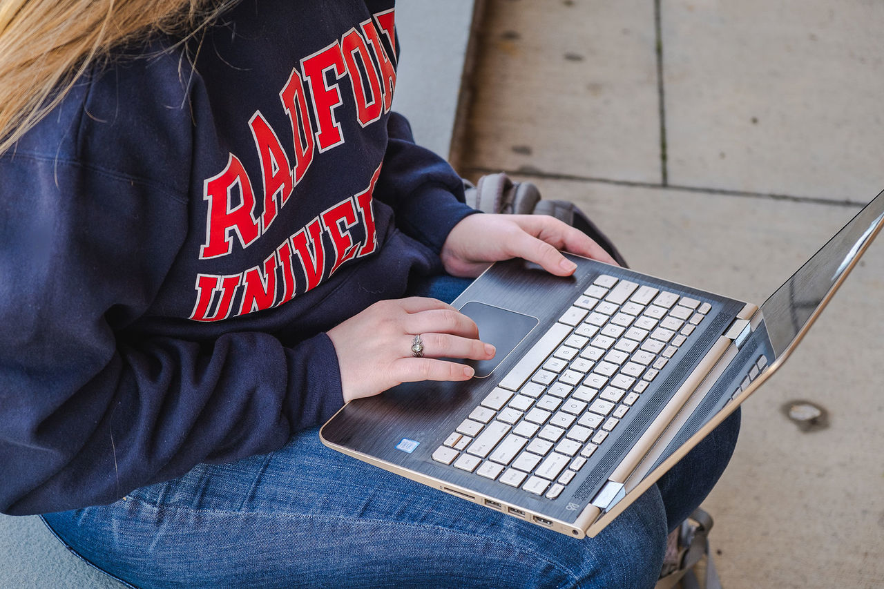 close up of someone typing on a laptop