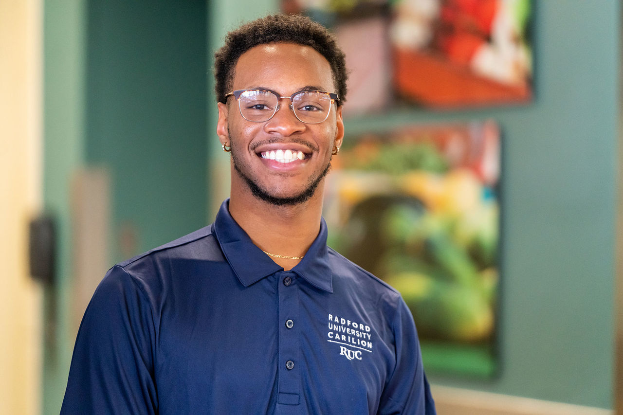 radford student in a blue polo smiling at the camera