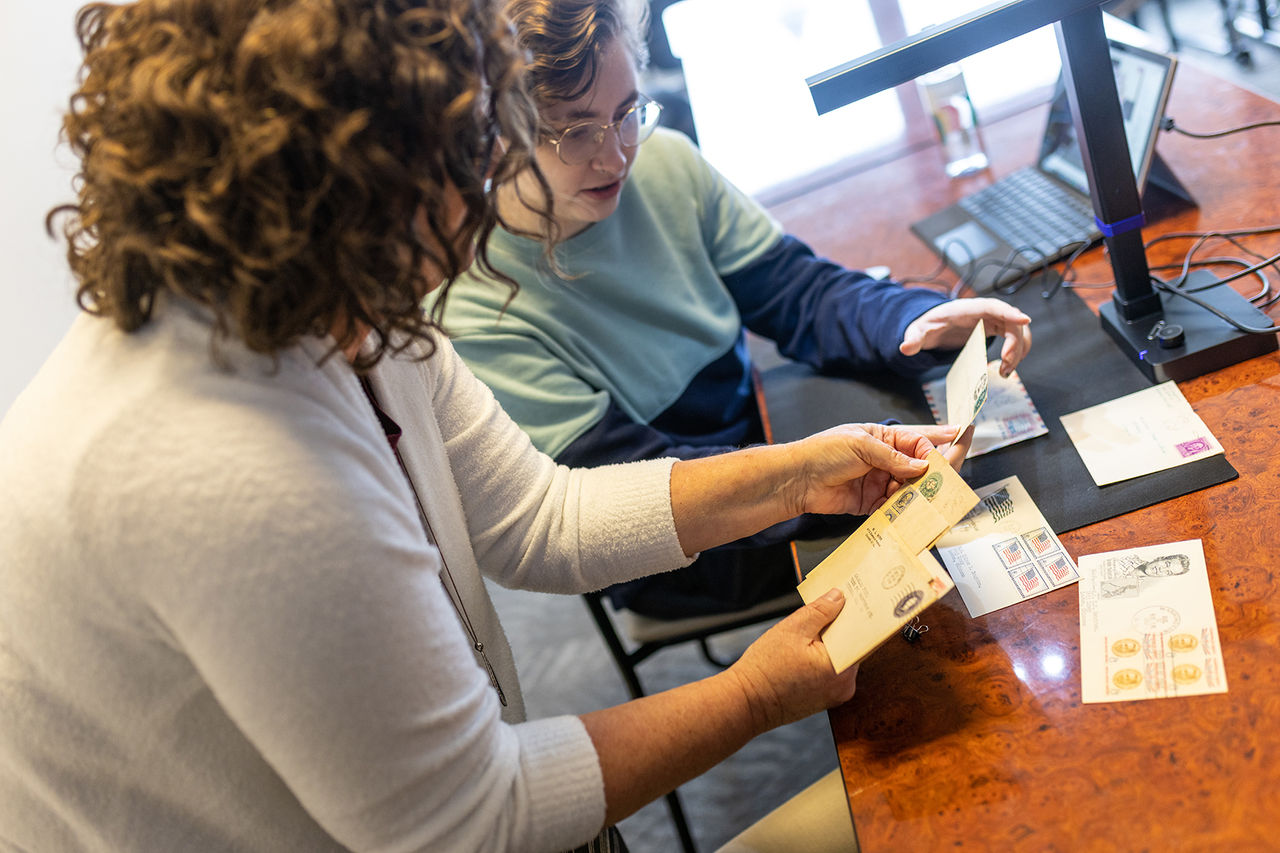 two students looking at letters