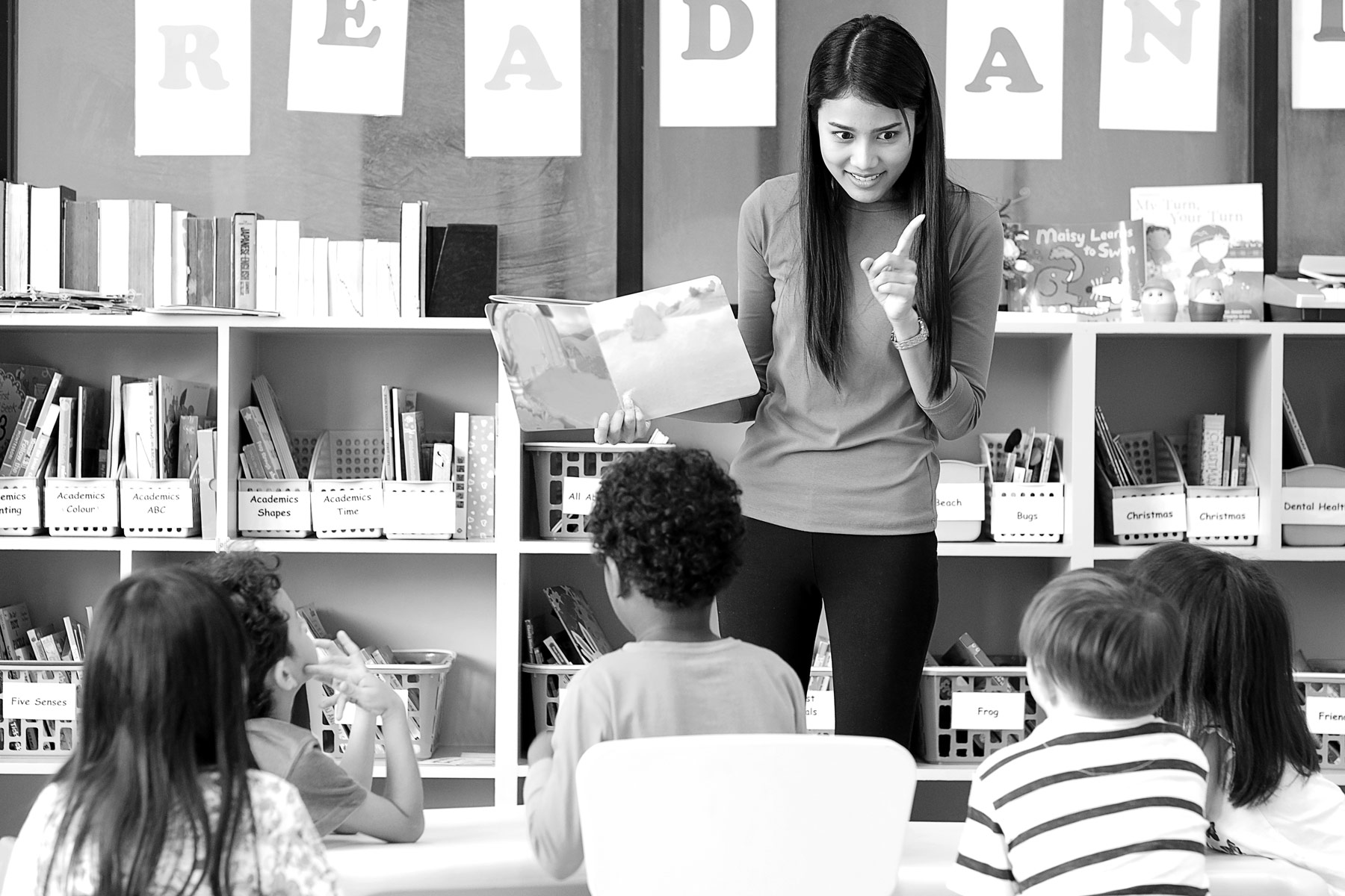 teacher in a classroom in front of school children