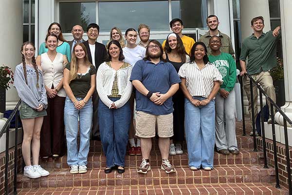 Industrial Organizational Psychology students take a photo on Hemphill Hall steps