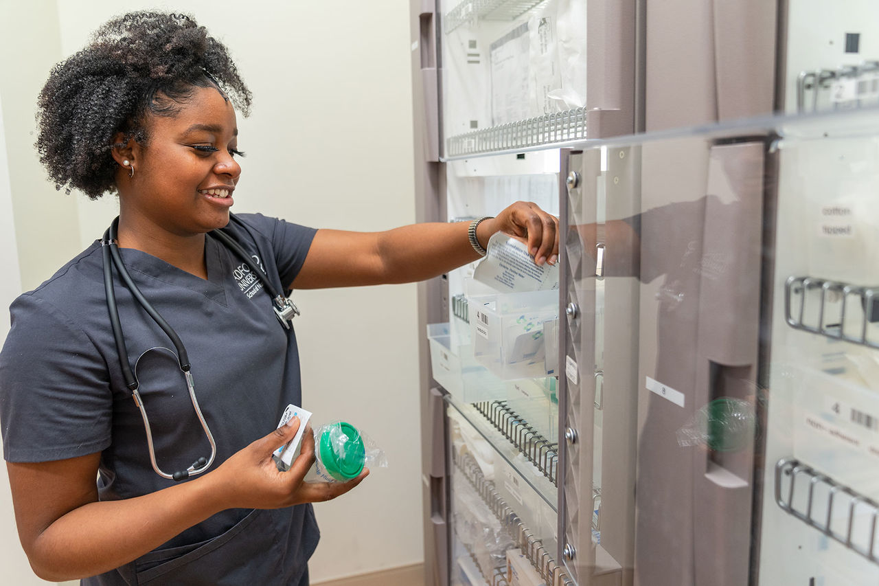 nursing student putting things away in a shelf