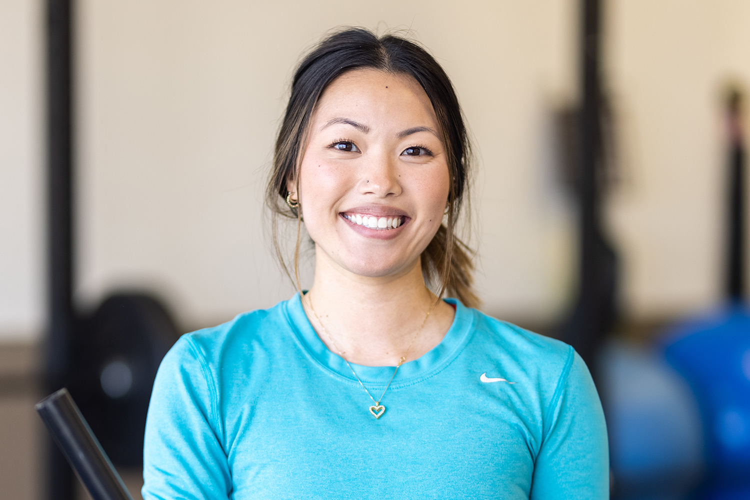 girl in a blue shirt smiling at the camera