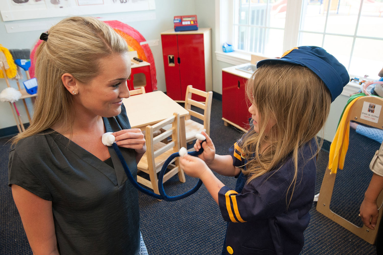 female student in classroom with young child