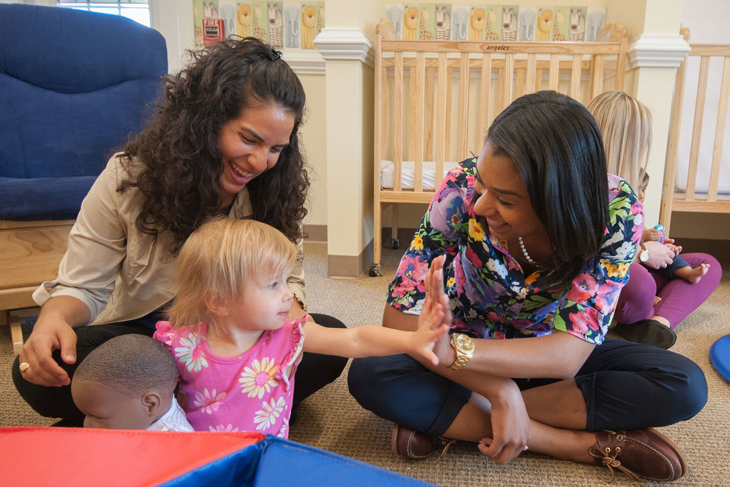 two women sitting with a child