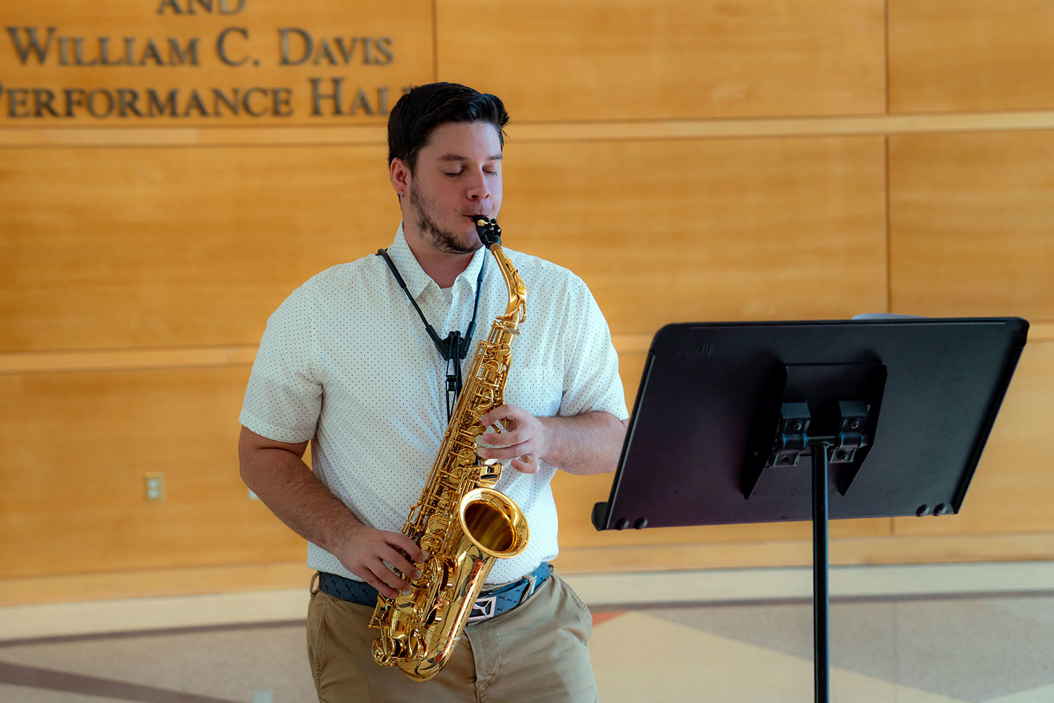 a male playing the saxophone