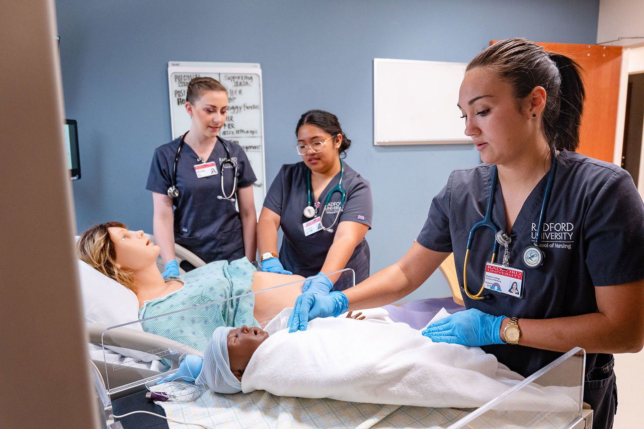 students with mannequin patients in labor and delivery
