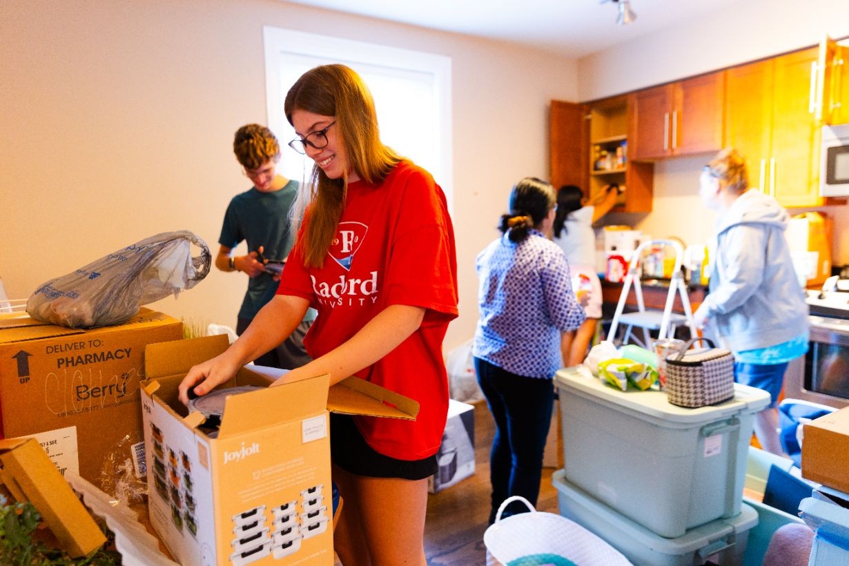student unpacking with family
