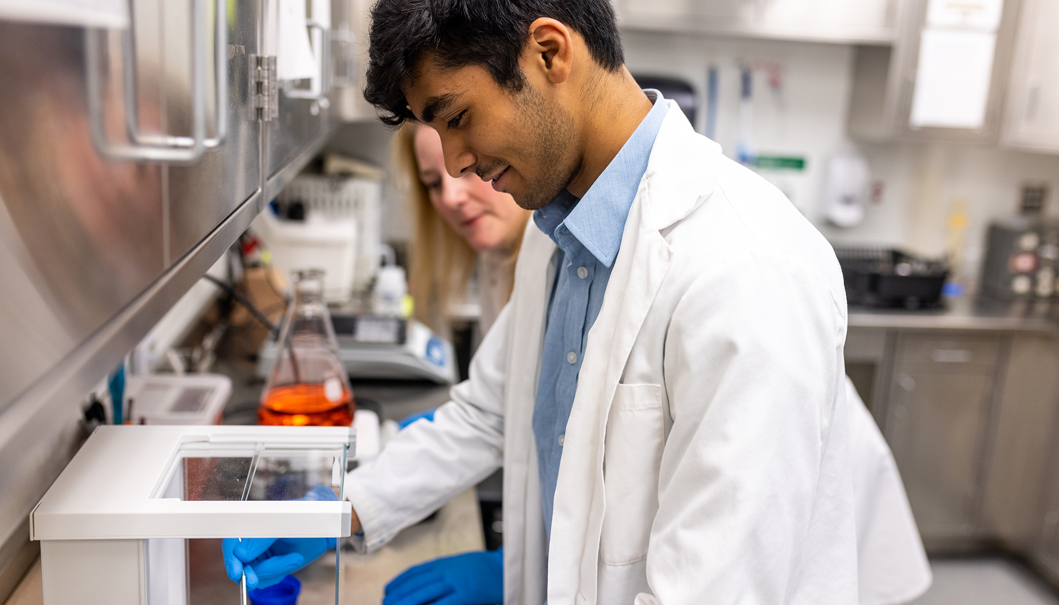 student and professor conducting research in a lab