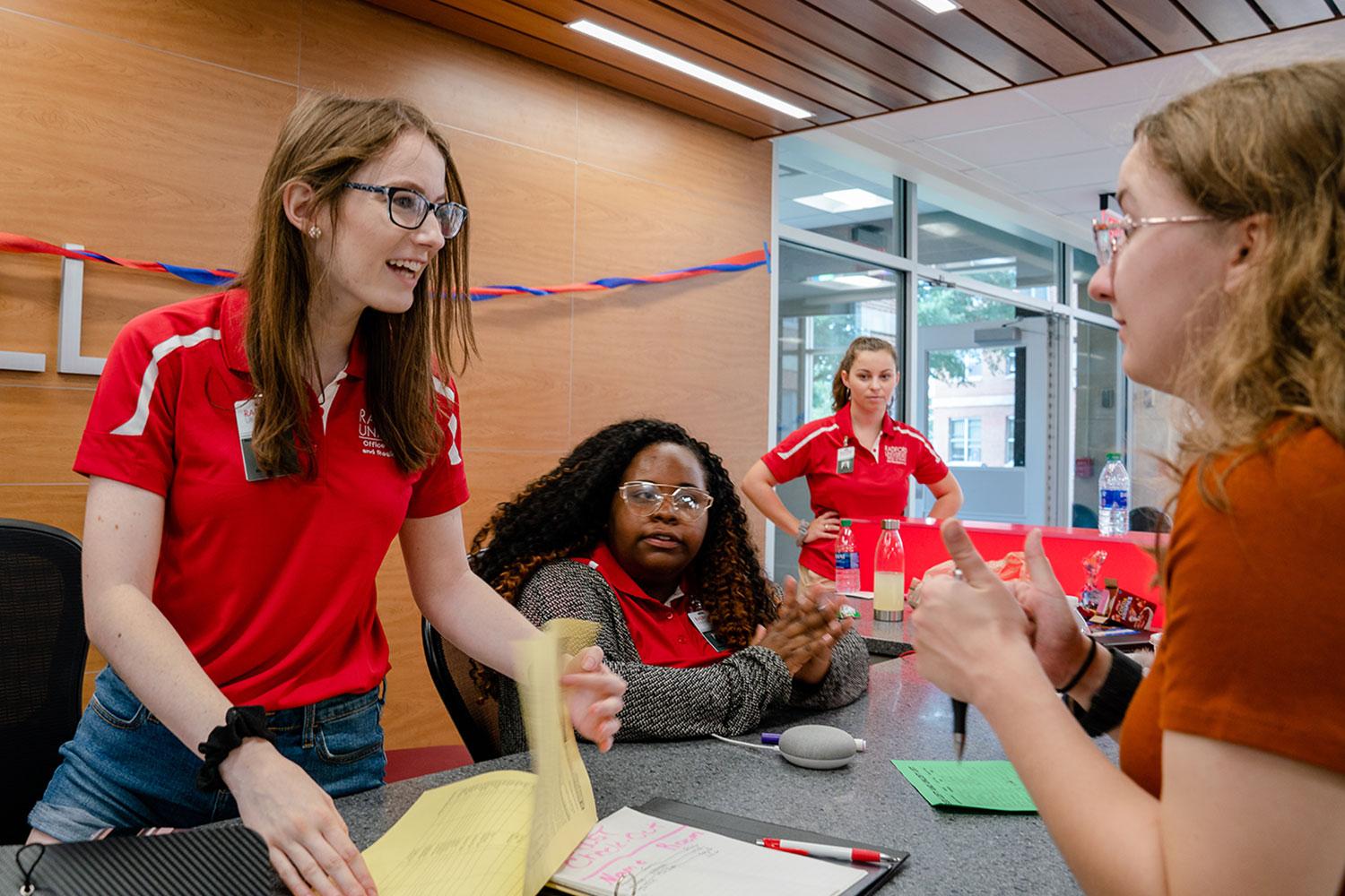 A quest assistant helping incoming students move in.