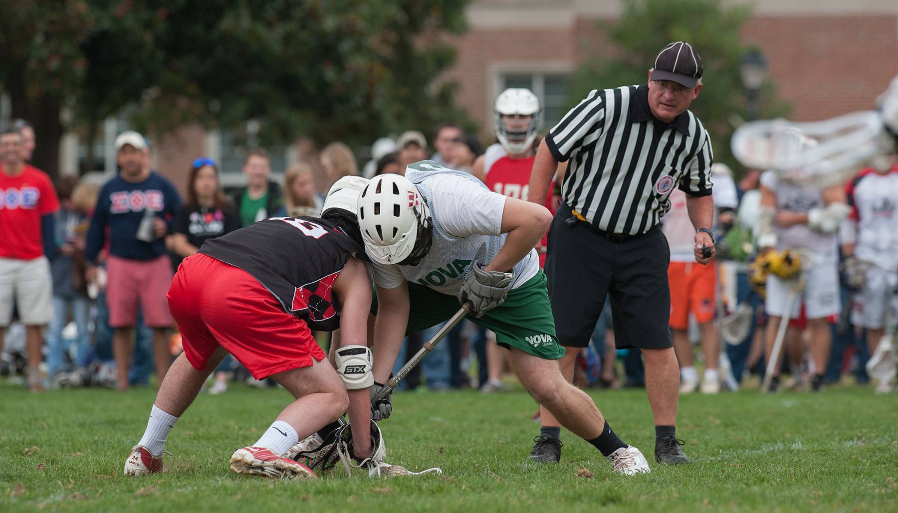 Students on the Men's Lacrosse club competing against another university.