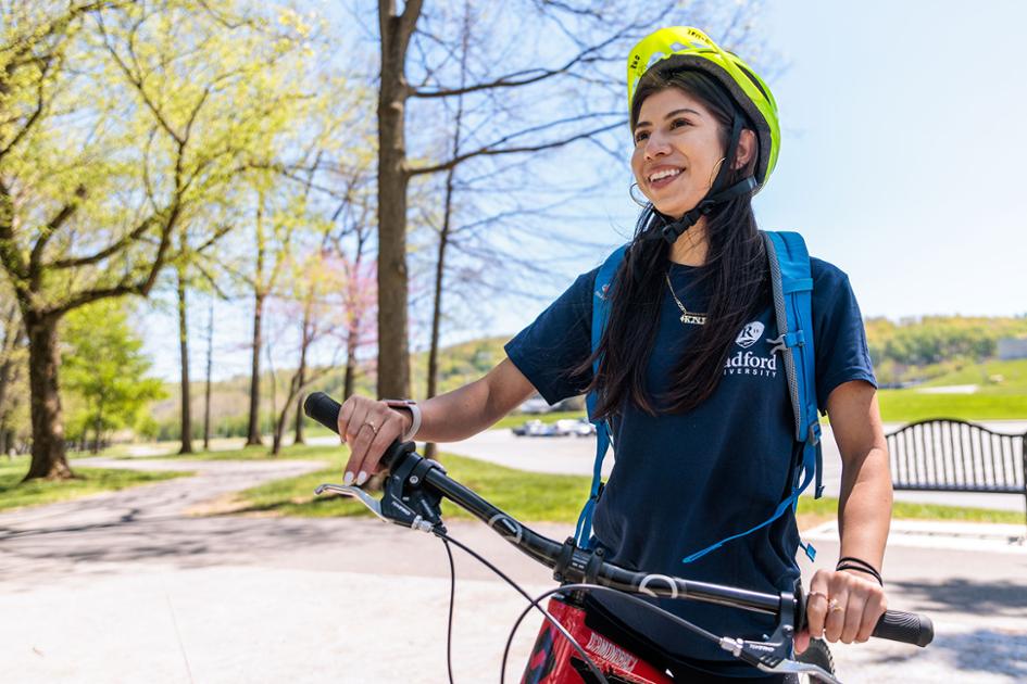 Radford University student riding a mountain bike on a local trail.