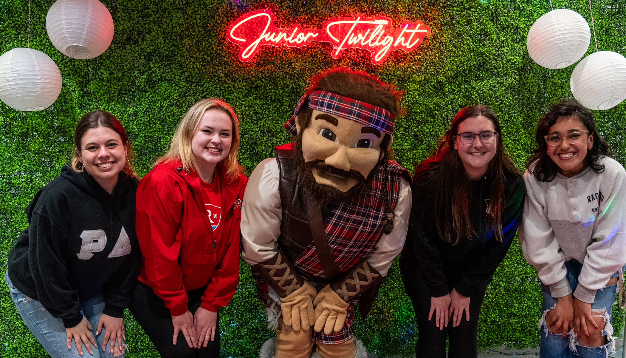 students take a photo with the highlander during junior twilight celebration