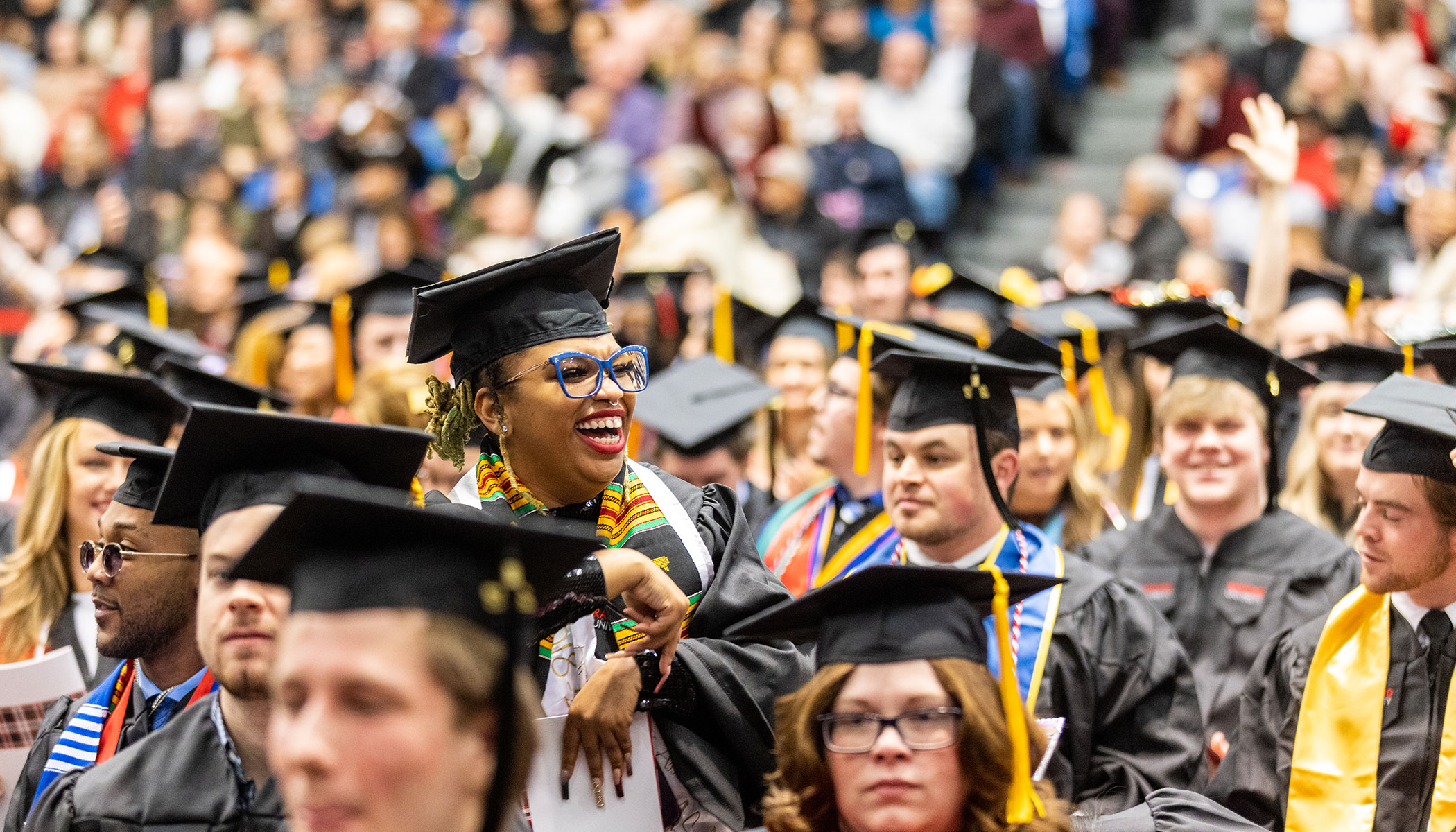 Students standing while being recognized at a Winter Commencement.